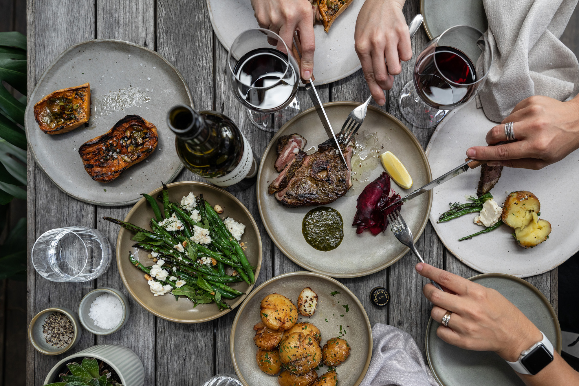 People eating steak and drinking wine 